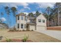 Two story home with a three car garage and landscaped yard at 63 Homesite Cooper W Cv, Fayetteville, GA 30214