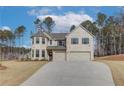 Two story home with a three car garage and landscaped yard at 63 Homesite Cooper W Cv, Fayetteville, GA 30214