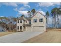 Two story home with a three car garage and landscaped yard at 63 Homesite Cooper W Cv, Fayetteville, GA 30214