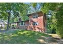 Brick house with a large green lawn and mature trees at 2953 Collier Nw Dr, Atlanta, GA 30318