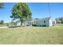 Newly constructed light green house with a spacious lawn and driveway at 11610 Highway 142, Covington, GA 30014