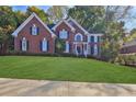 Brick two-story home with manicured lawn at 1620 Silverleaf Way, Alpharetta, GA 30005