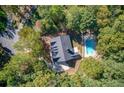 Aerial view of a house with a pool and surrounded by trees at 436 Westlake Dr, Marietta, GA 30064