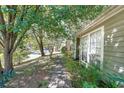 Sidewalk view of house exterior and landscaping at 3884 Wood Path Dr, Stone Mountain, GA 30083