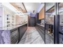 Modern kitchen with dark cabinetry, granite countertops, and wine cooler at 3334 Peachtree Ne Rd # 1209 1210, Atlanta, GA 30326