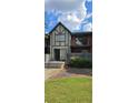 Brick building with balcony and landscaping at 6851 Roswell Rd # O9, Atlanta, GA 30328