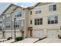 Two-story townhome with attached garage and neutral exterior at 1801 Liberty Nw Pkwy, Atlanta, GA 30318