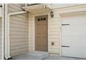 Exterior view of the home showcasing a tan door and attached garage at 1801 Liberty Nw Pkwy, Atlanta, GA 30318