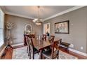 Formal dining room with hardwood floors, a chandelier, and a large window at 1720 Mountainside Dr, Cumming, GA 30040