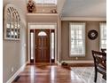 Bright entryway with hardwood floors, a large mirror, and a decorative door at 1720 Mountainside Dr, Cumming, GA 30040