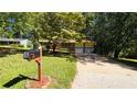 Two-story house with yellow siding, attached garage and driveway at 1043 S Millard Way, Stone Mountain, GA 30088