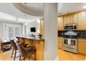 Open kitchen with breakfast bar, wood cabinets, and stainless steel appliances at 2255 Peachtree Rd # 328, Atlanta, GA 30309