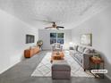 Virtually staged living room featuring a gray sofa, coffee table, and stylish rug at 3217 Fairington Dr, Lithonia, GA 30038