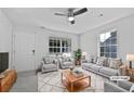 Virtually staged living room with comfortable seating and large windows at 5667 Chrys St, Powder Springs, GA 30127