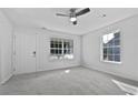 Bright living room with neutral walls and carpet at 5667 Chrys St, Powder Springs, GA 30127