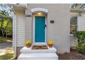 Welcoming teal front door with potted mums at 1880 Vesta Ave, Atlanta, GA 30337