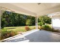 Spacious front porch with ornate columns, overlooking a grassy yard at 2620 Old Covington Ne Rd, Conyers, GA 30013