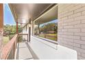 Covered porch with wood railing and brick exterior at 3611 Hillsborough Ln, Decatur, GA 30032