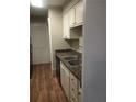 Kitchen with white cabinets and granite countertops at 172 Rue Fontaine, Lithonia, GA 30038