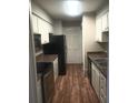 Galley kitchen with stainless steel appliances at 172 Rue Fontaine, Lithonia, GA 30038