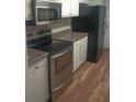 Kitchen with stainless steel appliances and wood floor at 172 Rue Fontaine, Lithonia, GA 30038