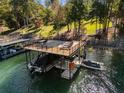 Private boat dock with large deck and covered area for boats and recreation at 6308 Woodlake Dr, Buford, GA 30518