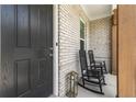 Charming front porch with black rocking chairs and brick exterior at 3445 Andover St, Cumming, GA 30028