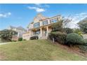 Brick house with a large front yard and a three-car garage at 1712 Country Wood Dr, Hoschton, GA 30548