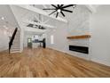 Open concept living room with hardwood floors, high ceilings, exposed beams, and a view of the kitchen at 865 Mcdaniel Sw St, Atlanta, GA 30310