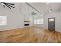 Bright and spacious living room featuring hardwood floors, high ceilings, exposed beams, and a modern fireplace at 865 Mcdaniel Sw St, Atlanta, GA 30310