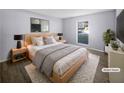 Virtually staged bedroom with light walls and hardwood floors at 1002 Cumberland Se Ct, Smyrna, GA 30080