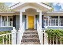 Inviting front porch with yellow door and stone steps at 1760 Barnesdale Ne Way, Atlanta, GA 30309