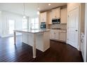 Eat-in kitchen with island, stainless steel appliances, and hardwood floors at 3864 Kastler Dr, South Fulton, GA 30349