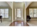 Two-story entryway with hardwood floors and a white door at 3191 Lake Mcginnis Dr, Suwanee, GA 30024
