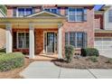Two-story home's front entrance with columns and landscaping at 3191 Lake Mcginnis Dr, Suwanee, GA 30024