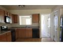 Kitchen with oak cabinets, appliances, and a pass-through at 6348 Wellington Walk Way, Lithonia, GA 30058