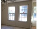 Living room with large windows and ceiling fan at 6348 Wellington Walk Way, Lithonia, GA 30058