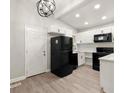 Modern kitchen with white shaker cabinets, quartz counters, and black appliances at 2396 Abner Nw Pl, Atlanta, GA 30318