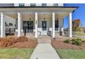 Brick front porch with light blue door at 4627 Molder Dr, Buford, GA 30518