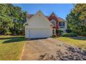 Two-story house with a white garage door at 2404 Lake Cove Ct, Lithonia, GA 30058