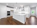 Modern kitchen with white cabinets and island at 118 Briargate Dr, Johns Creek, GA 30097