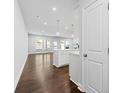 View of kitchen and living area with hardwood floors at 118 Briargate Dr, Johns Creek, GA 30097