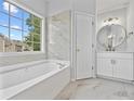 Updated bathroom with marble flooring and soaking tub at 2871 Belfaire Lake Dr, Dacula, GA 30019