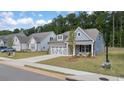 Gray-blue house with white accents and a two-car garage at 51 Airmont Dr, Sharpsburg, GA 30277