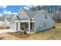 Craftsman style home with gray siding and stone accents at 51 Airmont Dr, Sharpsburg, GA 30277
