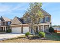 Two-story home with stone and siding exterior at 7307 Parkland Bnd, Fairburn, GA 30213