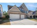 Two-story home with stone and siding exterior at 7307 Parkland Bnd, Fairburn, GA 30213