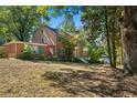 Side view of the brick house showcasing the landscape and house's architectural details at 2490 Cascade Sw Rd, Atlanta, GA 30311