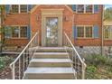 Front entrance with brick stairs and ornate railing leading to the front door at 2490 Cascade Sw Rd, Atlanta, GA 30311