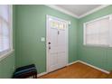 Bright entryway with green walls, hardwood floors, and a coat of paint at 2490 Cascade Sw Rd, Atlanta, GA 30311